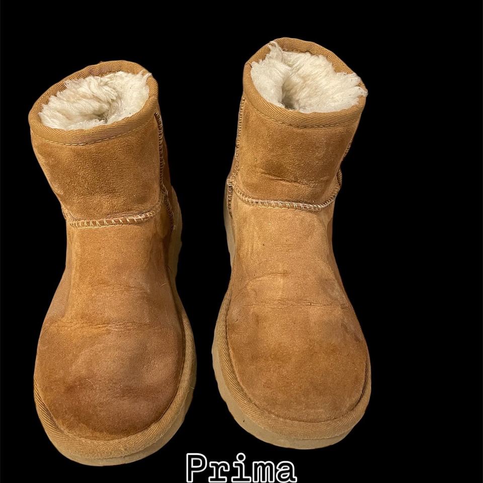 Un paio di UGG in camoscio viste di fronte, sporche e macchiate, prima del lavaggio